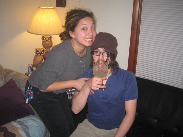 Daniella making a silly face and Bryce drinking a magarita sarcastically